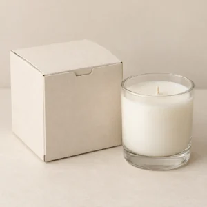 AI concept: ivory folding candle carton with a clear glass jar candle, catalog view.