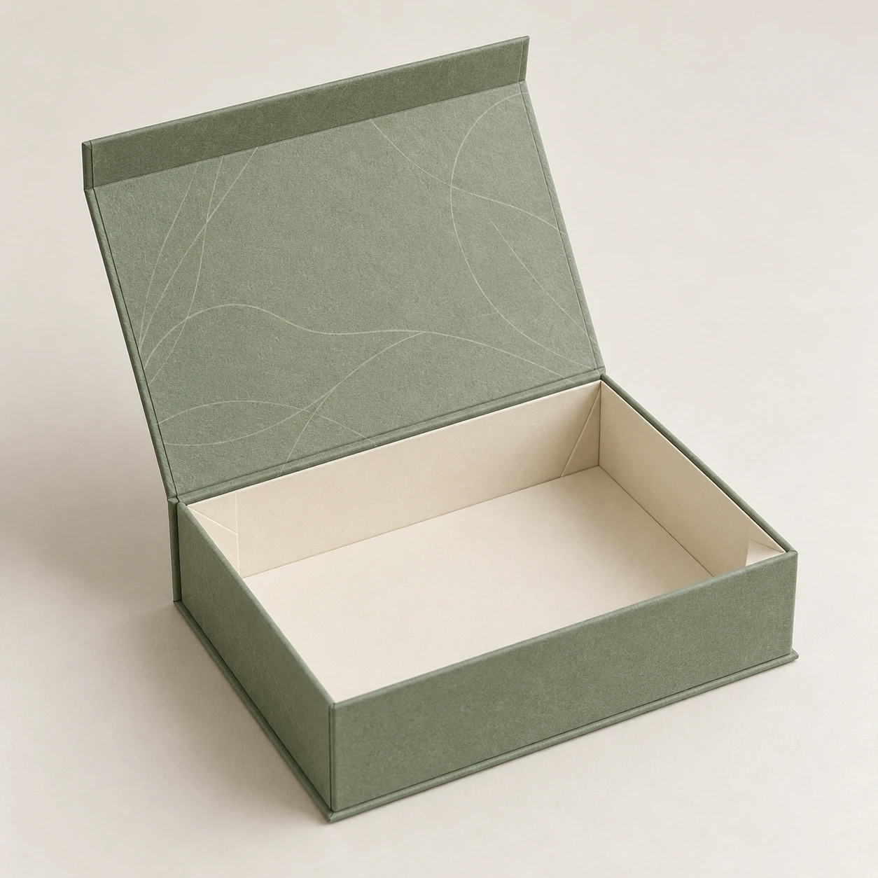 AI concept: an open sage collapsible rigid box with an attached cover, ivory lining and visible folding corner joints.