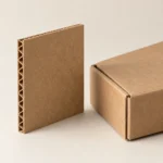 AI concept: brown corrugated samples with exposed fluted edges beside a kraft box.