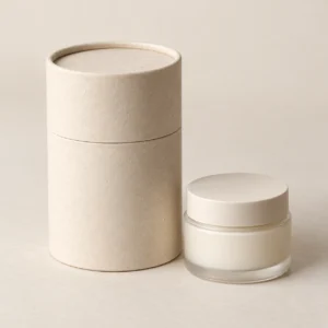 AI concept: ivory cylindrical cosmetic pack with a light-coloured jar, catalog view.