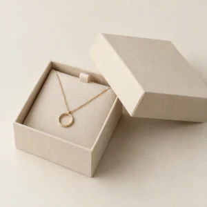 AI concept: ivory jewelry presentation box with a pendant necklace, catalog view.