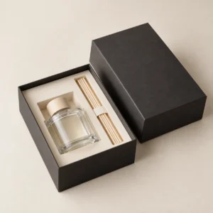 AI concept: charcoal diffuser presentation box with an ivory bottle-and-reed layout, catalog view.