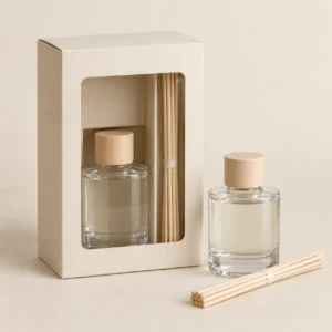 AI concept: ivory windowed diffuser carton with a bottle and reed bundle, catalog view.