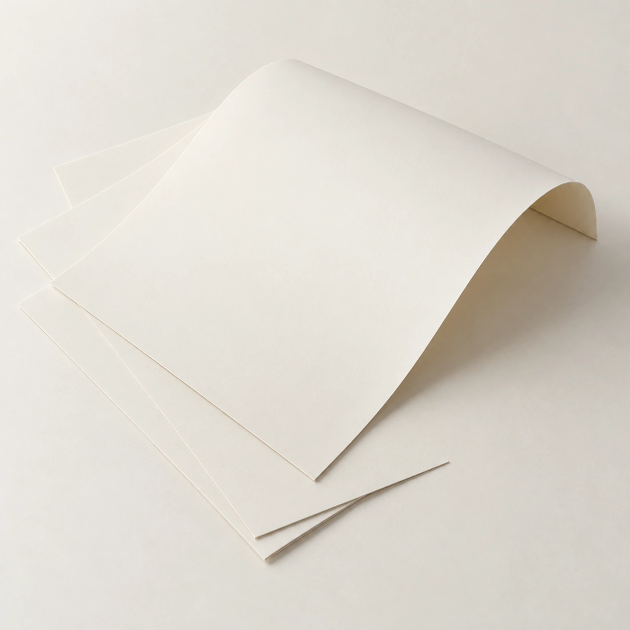 AI concept: thin ivory folding boxboard sheets, gently fanned with one curved sheet.