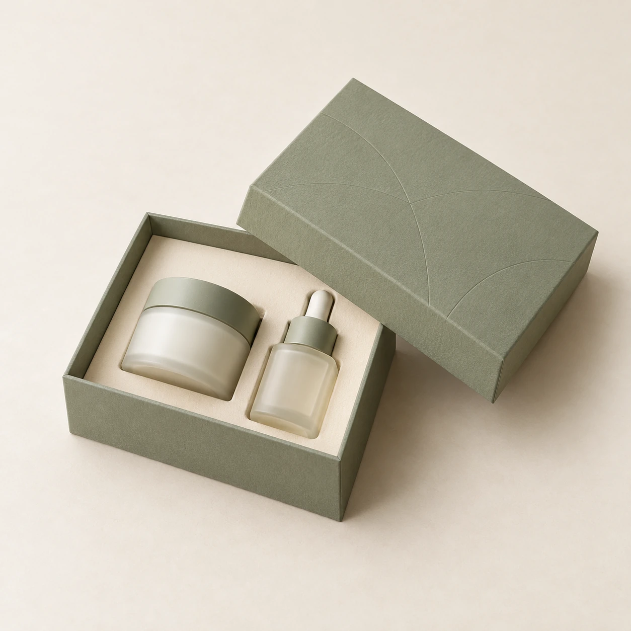 AI concept: a sage rigid gift box with an ivory insert holding a small jar and dropper bottle.