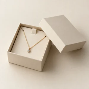 AI concept: ivory necklace box with a pendant chain on a sloping support, catalog view.