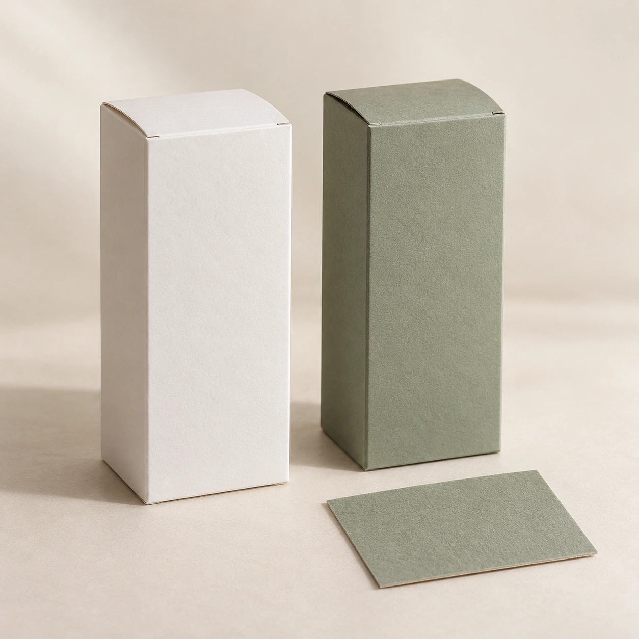 AI concept: white and muted sage tall carton concepts with a matching sage material sample.