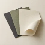 AI concept: ivory, sage and charcoal textured decorative paper samples.