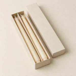 AI concept: long ivory candle box with slim taper candles arranged in channels, catalog view.