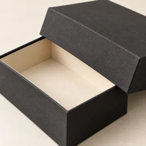 AI concept: charcoal rectangular presentation box with a separate lid and ivory interior, detail view.
