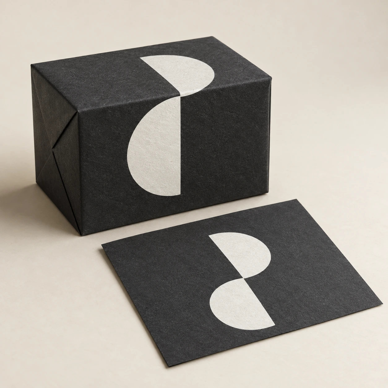 AI concept: a dark charcoal carton and paper sample with a flat white geometric print.
